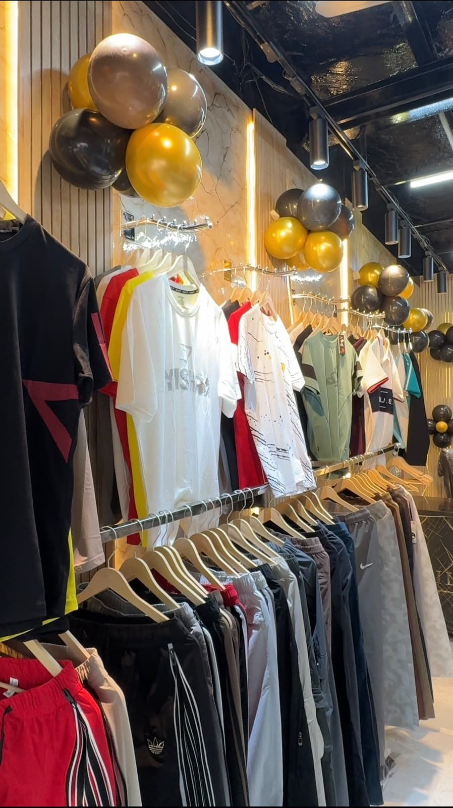 Racks of T-shirts and lowers inside Illusion Clothing